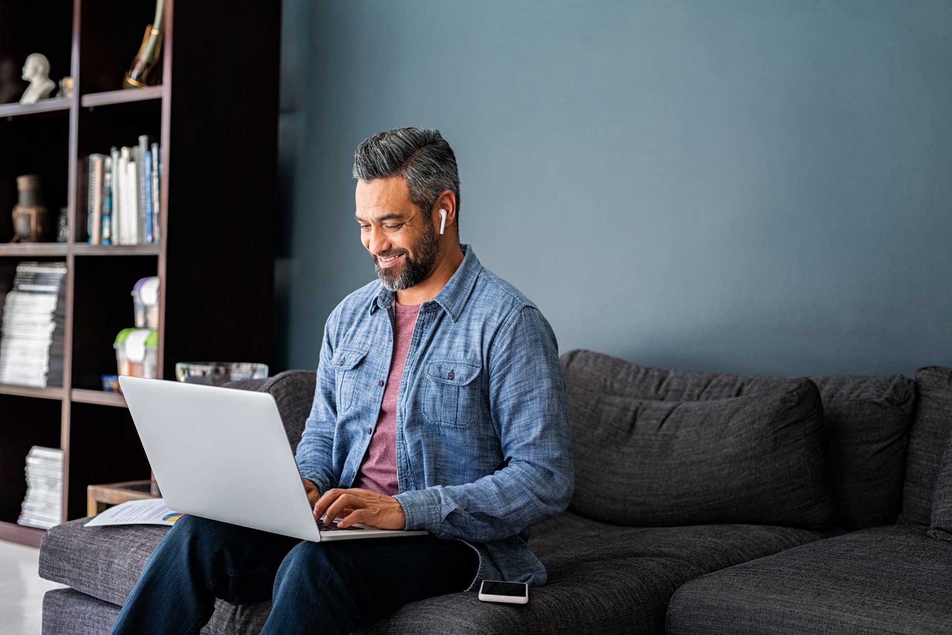 Man Typing on Laptop While Working from Home